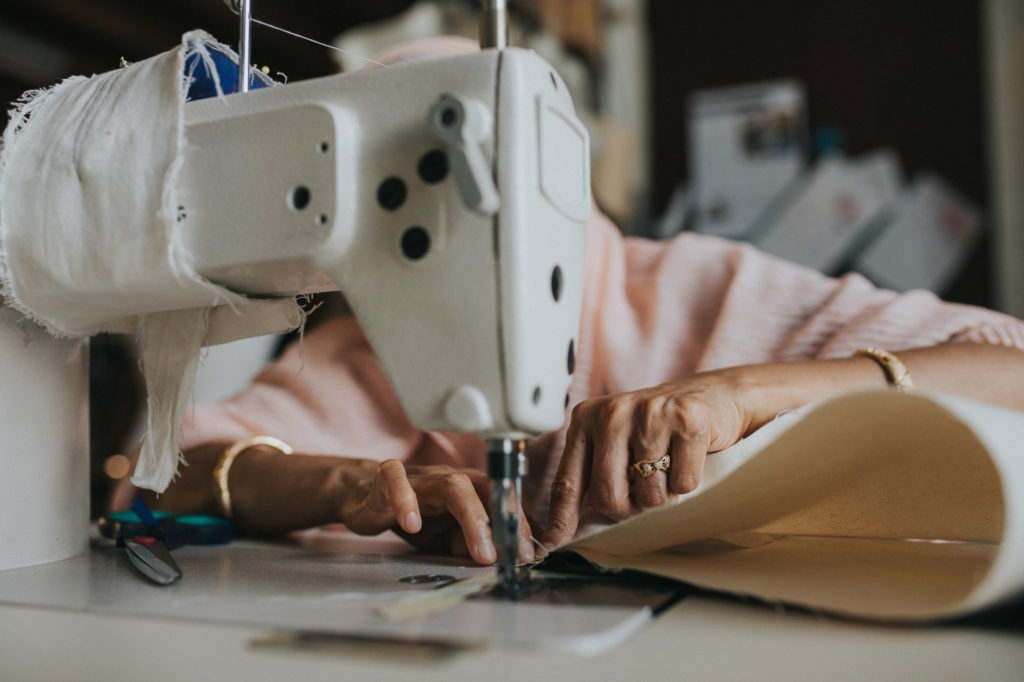 Asylum seeker woman sewing for ethical community charity for Aerende ethical homeware by Emma Collins
