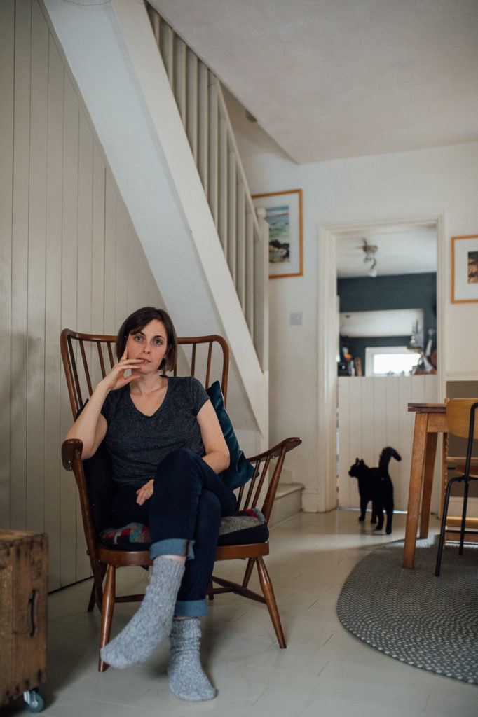 Environmental portrait of woman in ercol chair by photographer Emma Collins