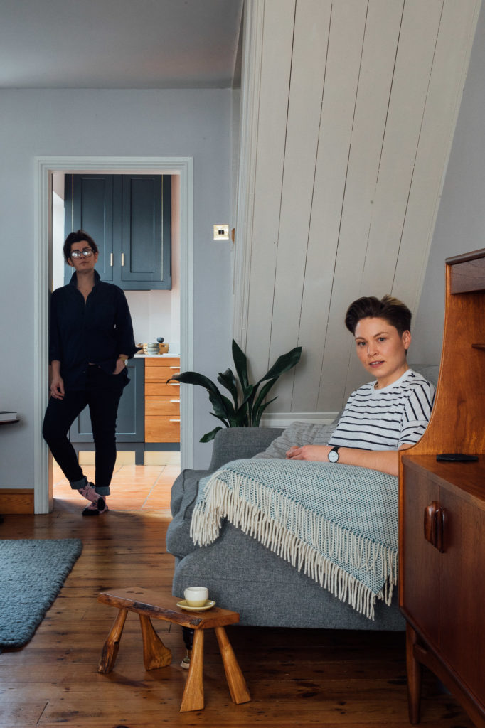 Portrait of female gay LGBT couple at home by Emma Collins photographer