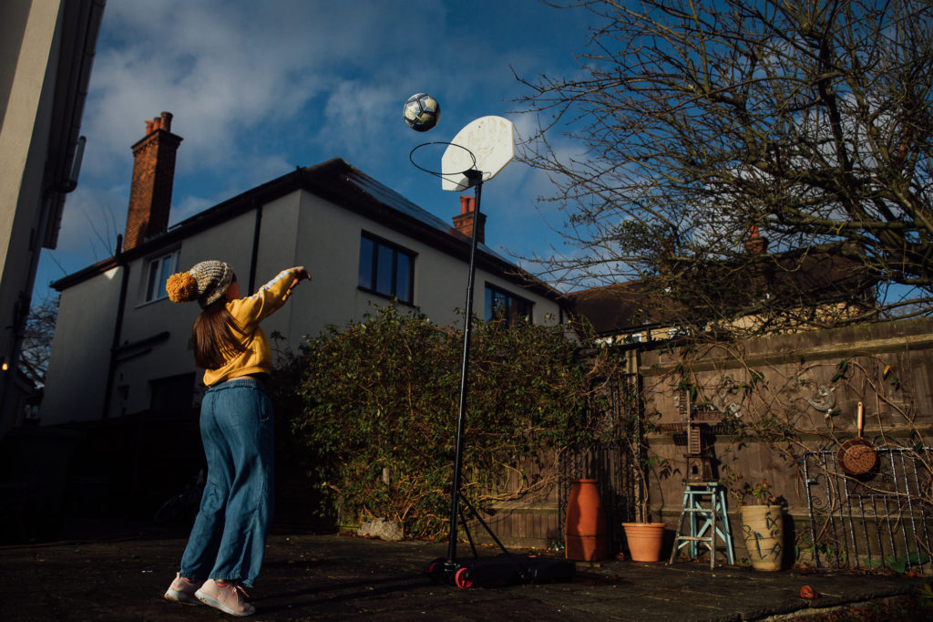 Photo of teen playing basketball by Emma Collins Photography