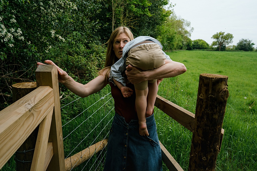 Mum carrying child everyday life captured by Emma Collins photographer in St Albans