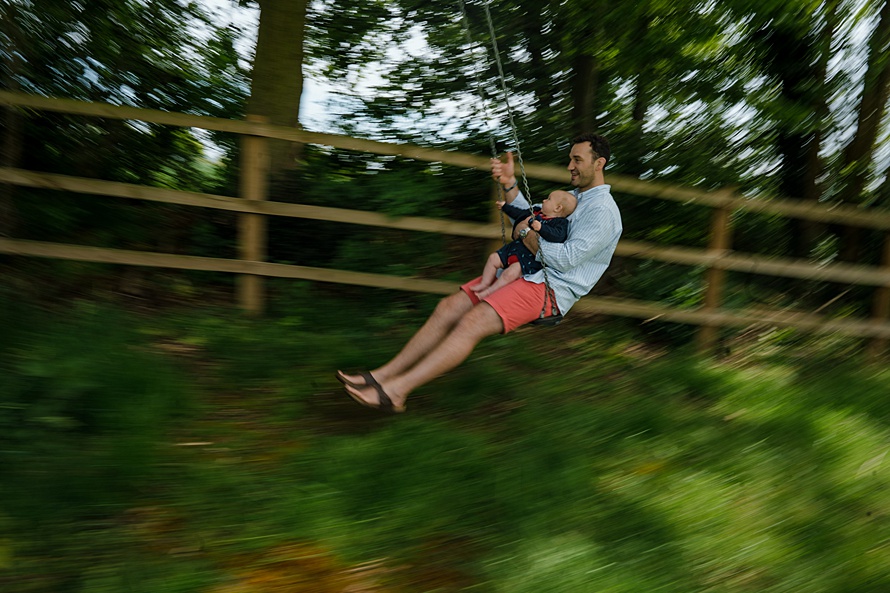 Dad on swing motion blur authentic family photography in Harpenden
