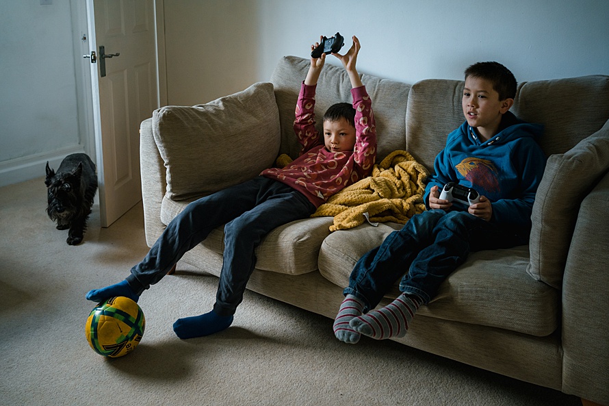 Brothers playing video games on PS4 XBox family photoshoot Cambridge