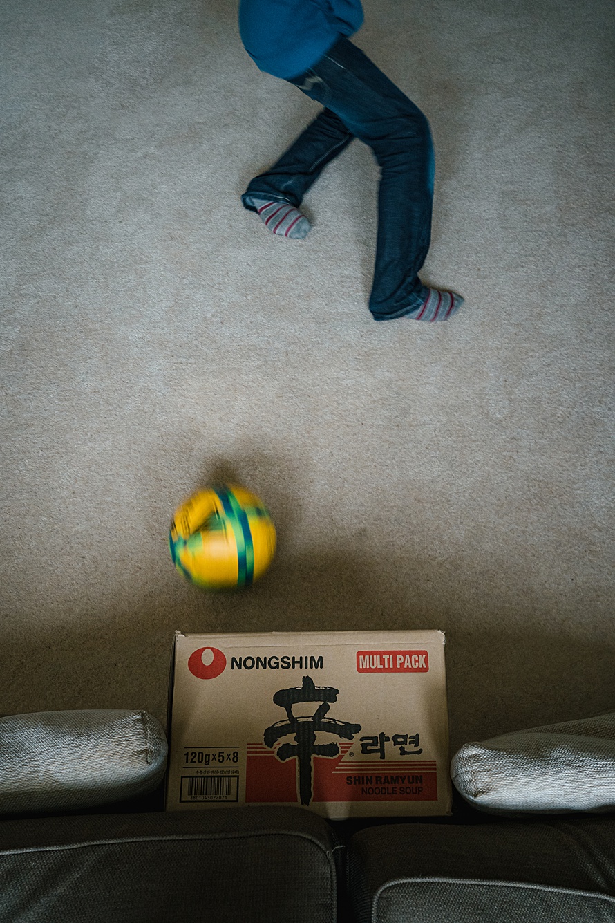Indoor football real life family photoshoot Cambridge by photographer Emma Collins