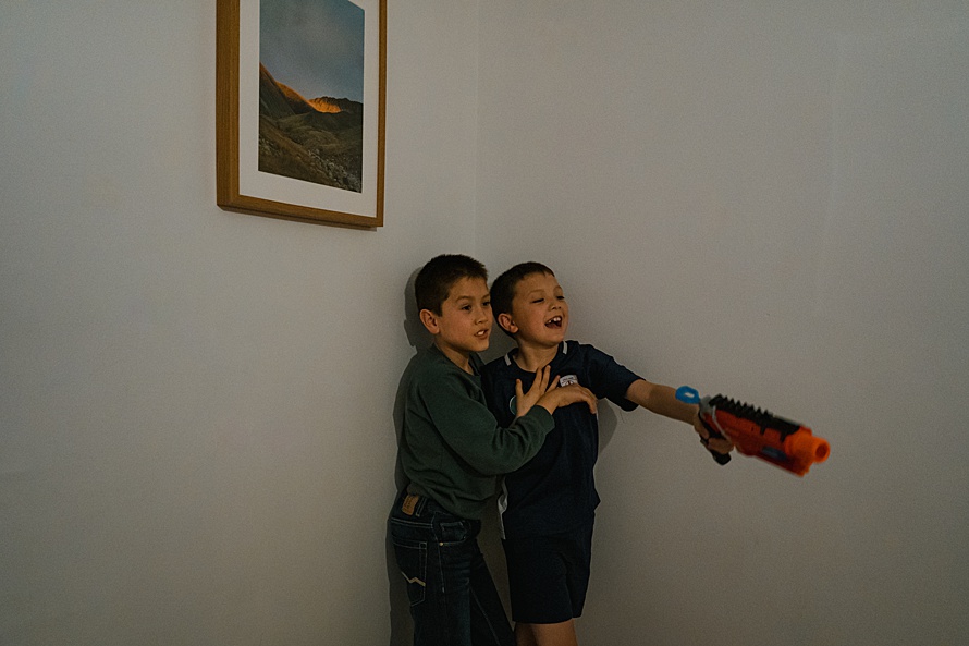 Boys with nerf guns captured on a Cambridge family photoshoot by documentary family photographer Emma Collins