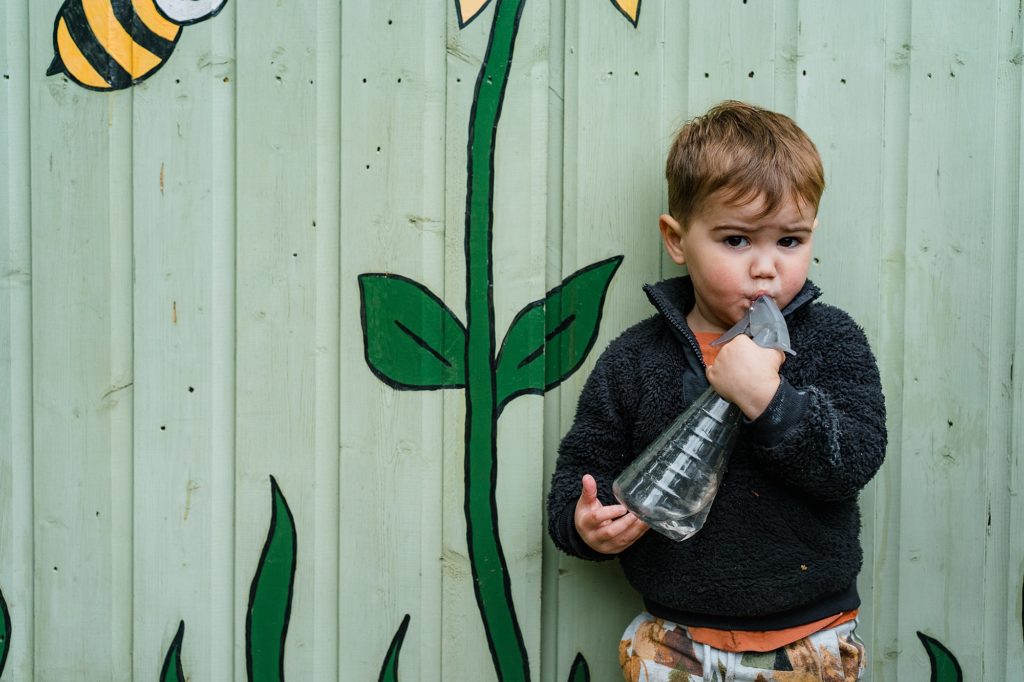 Little boy drinking from a water spray, St Albans nursery photography