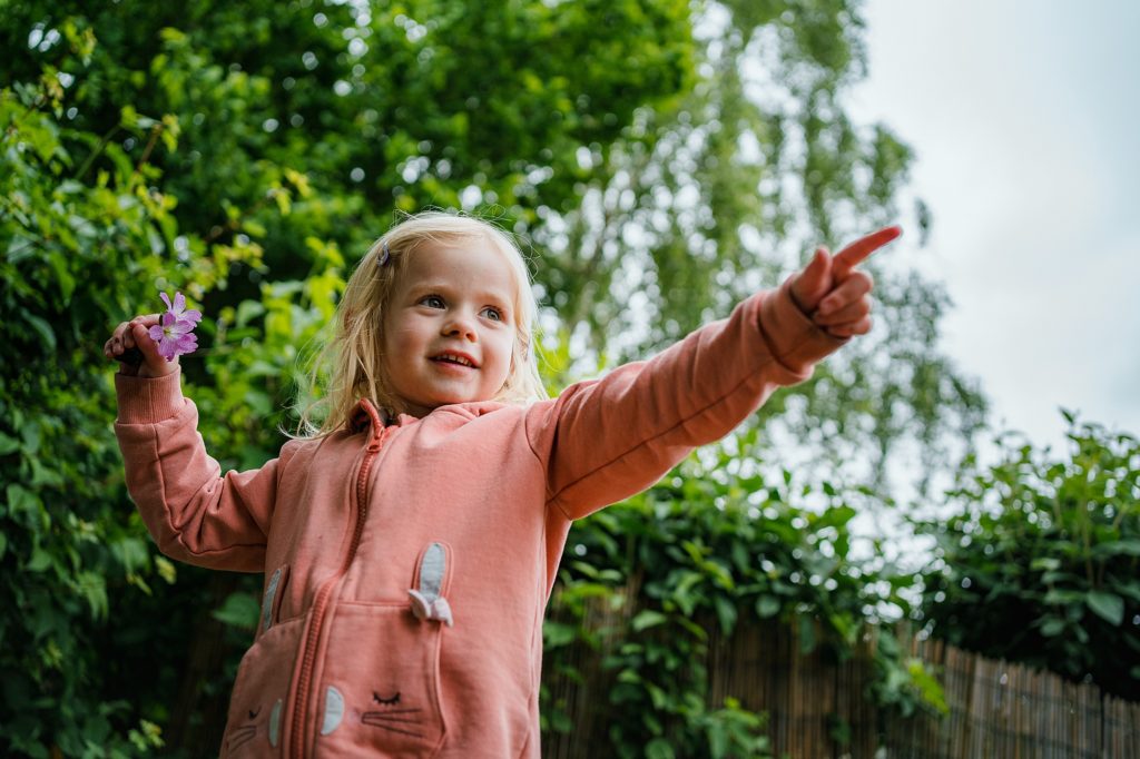 Portrait of a cheeky little girl pointing, St Albans Nursery photographer