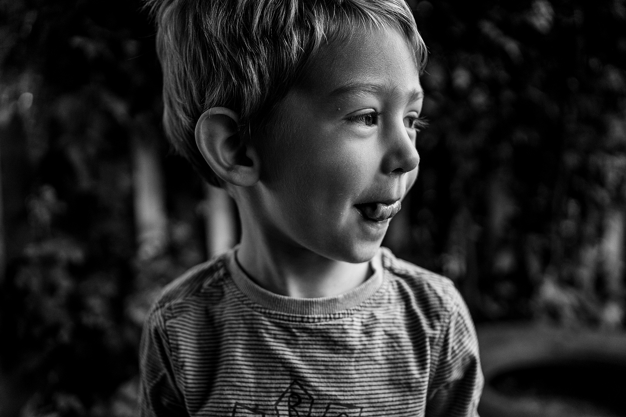 portrait of cute little boy with tongue sticking out, natural portrait photographer Emma Collins