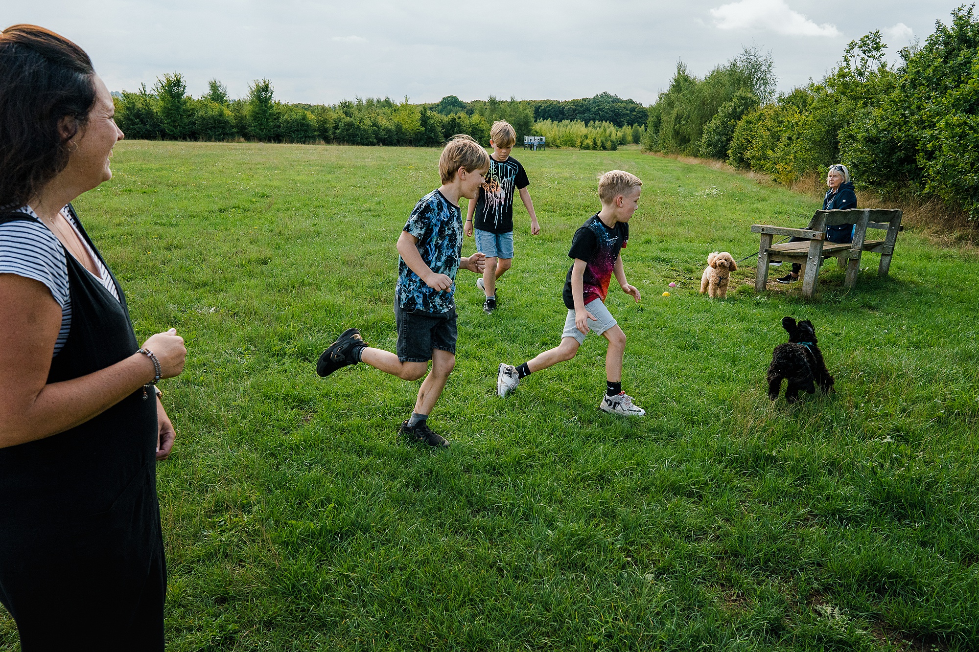 Brothers running on dog walk on Family documentary photo session in St Albans