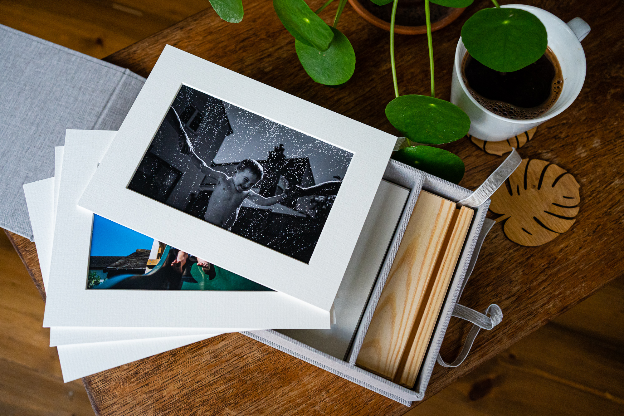 Selection of professional family photograph prints displayed on a coffee table